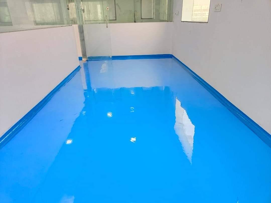 High-gloss epoxy floor with a bright, reflective sealed surface